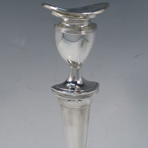 A very handsome and large pair of Sterling Silver candlesticks, having neoclassical plain oval boat-shaped bodies with reeded borders and tapering columns, and original removable nozzles. These elegant silver candlesticks were made by D. J. Silver of London in 1965. The dimensions of these fine hand-made silver candlesticks are height 30.5 cms (12 inches), and the bases are 16.5 cms (6.5 inches) long.   