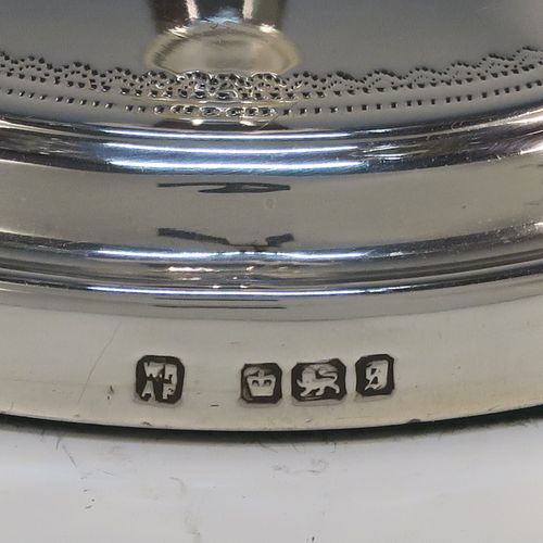 A very handsome pair of Antique Edwardian Sterling Silver candlesticks, having neoclassical round  octagonal panelled bodies with reeded borders and tapering columns, and original removable nozzles. These elegant antique silver candlesticks were made by Fordham and Faulkner of Sheffield in 1910. The dimensions of these fine hand-made antique silver candlesticks are height 25.5 cms (10 inches), and the bases are 12 cms (4.75 inches) in diameter.   
