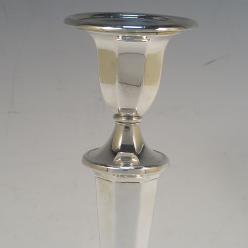 A very handsome pair of Antique Edwardian Sterling Silver candlesticks, having neoclassical round  octagonal panelled bodies with reeded borders and tapering columns, and original removable nozzles. These elegant antique silver candlesticks were made by Fordham and Faulkner of Sheffield in 1910. The dimensions of these fine hand-made antique silver candlesticks are height 25.5 cms (10 inches), and the bases are 12 cms (4.75 inches) in diameter.   