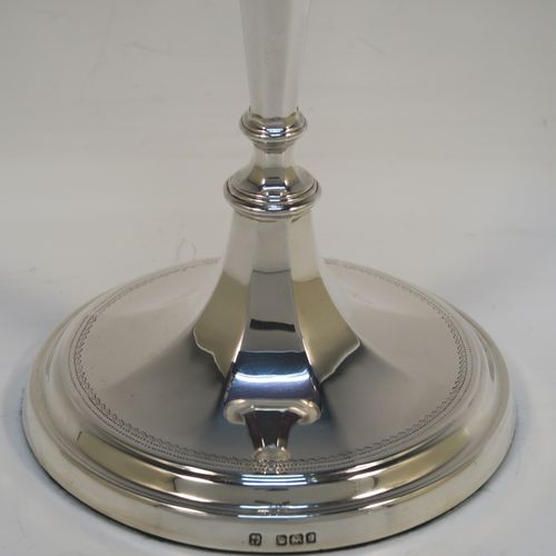 A very handsome pair of Antique Edwardian Sterling Silver candlesticks, having neoclassical round  octagonal panelled bodies with reeded borders and tapering columns, and original removable nozzles. These elegant antique silver candlesticks were made by Fordham and Faulkner of Sheffield in 1910. The dimensions of these fine hand-made antique silver candlesticks are height 25.5 cms (10 inches), and the bases are 12 cms (4.75 inches) in diameter.   