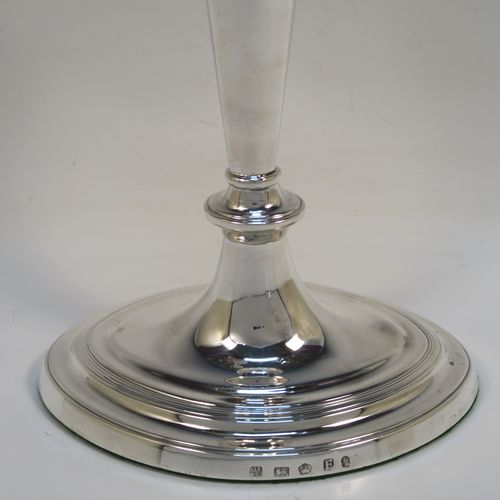 A very handsome pair of Antique Georgian Sterling Silver candlesticks, having neoclassical plain oval boat-shaped bodies with reeded borders and tapering columns, and original removable nozzles. These elegant antique silver candlesticks were made by Joseph Shemell of Sheffield in 1799. The dimensions of these fine hand-made antique silver candlesticks are height 26 cms (10.25 inches), and the bases are 14 cms (5.5 inches) long.   