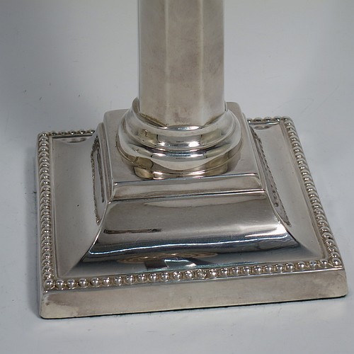 An Antique Victorian Sterling Silver pair of very pretty table candlesticks with bead-edged borders, having square bases with straight hexagonal panelled columns, with plain round capitals and removable nozzles. Made by Martin Hall and Co., of Sheffield in 1897. The dimensions of this fine hand-made pair of antique silver candlesticks are height 23 cms (9 inches), and 11 cms (4.3 inches) square at the base.