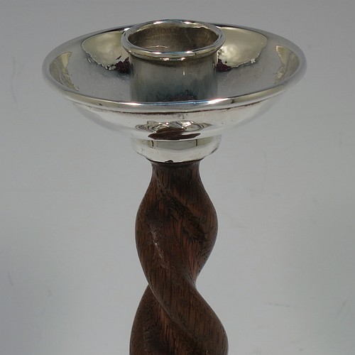A very unusual and pretty Sterling Silver pair of Arts and Crafts candlesticks, having round bases with a hand-hammered finish and applied rope-twist lower borders, with hand-carved wooden swirl columns, and round capitals with deep drip pans. Made by A. E. Jones of Birmingham in 1920. The dimensions of these fine hand-made Arts and Crafts silver candlesticks are height 17 cms (6.75 inches), and diameter at base 10 cms (4 inches).