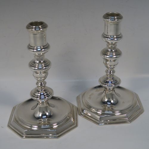 A very elegant pair of cast Sterling Silver candlesticks in a George I style, having plain round baluster bodies, and sitting on plain octagonal bases. These handsome silver candlesticks were made by Goldsmiths and Silversmiths of Sheffield in 1931. The dimensions of this fine pair of hand-made silver table candlesticks are height 19 cms (7.5 inches), the bases are 12.5 cms (5 inches) square, and the total weight is 805g (26 troy ounces)   
