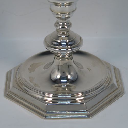 A very elegant pair of cast Sterling Silver candlesticks in a George I style, having plain round baluster bodies, and sitting on plain octagonal bases. These handsome silver candlesticks were made by Goldsmiths and Silversmiths of Sheffield in 1931. The dimensions of this fine pair of hand-made silver table candlesticks are height 19 cms (7.5 inches), the bases are 12.5 cms (5 inches) square, and the total weight is 805g (26 troy ounces)