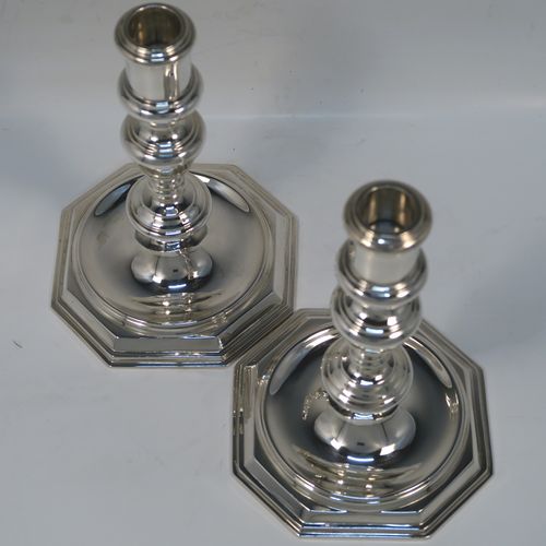 A very elegant pair of cast Sterling Silver candlesticks in a George I style, having plain round baluster bodies, and sitting on plain octagonal bases. These handsome silver candlesticks were made by Goldsmiths and Silversmiths of Sheffield in 1931. The dimensions of this fine pair of hand-made silver table candlesticks are height 19 cms (7.5 inches), the bases are 12.5 cms (5 inches) square, and the total weight is 805g (26 troy ounces)