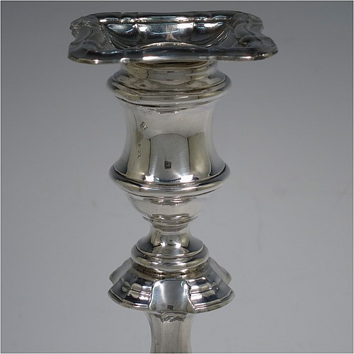A handsome Sterling Silver pair of candlesticks in the George II four-shell corner style, having baluster bodies, with shaped square bases and shell corners, fluted baluster columns, and removable nozzles. Made by F & F of Sheffield in 1927. The dimensions of these fine hand-made silver candlesticks are height 24 cms (9.5 inches), and base 11 cms (4.25 inches) square.