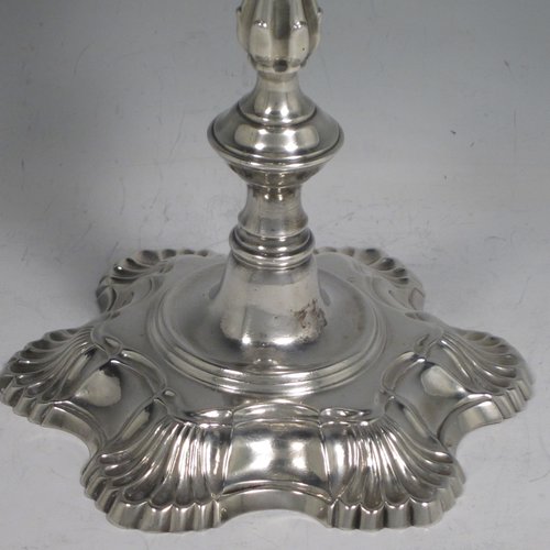 Antique Georgian cast sterling silver pair of George II candlesticks, having baluster bodies, with six-shell bases, and removable nozzles. Made by John Cafe of London in 1751/52. The dimensions of this fine pair of hand-made silver candlesticks are height 21.5 cms (8.5 inches), width at base 13 cms (5.25 inches), and they weigh a total of 1,054g (34 troy ounces).