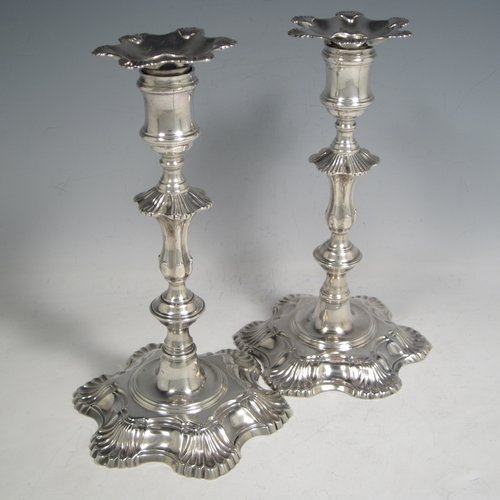 Antique Georgian cast sterling silver pair of George II candlesticks, having baluster bodies, with six-shell bases, and removable nozzles. Made by John Cafe of London in 1751/52. The dimensions of this fine pair of hand-made silver candlesticks are height 21.5 cms (8.5 inches), width at base 13 cms (5.25 inches), and they weigh a total of 1,054g (34 troy ounces).