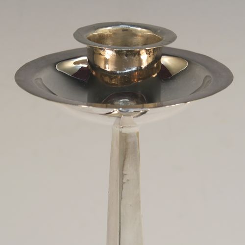 A handsome pair of Arts and Crafts style Antique Sterling Silver candlesticks, having plain square cross-section tapering columns, plain round nozzles with drip pans, and sitting on square bases with rivetted style decorated corners. These elegant antique silver Arts and Crafts candlesticks were made by James Dixon and Sons of Sheffield in 1918. The dimensions of these fine hand-made pair of antique silver table candlesticks are height 21.5 cms (8.5 inches), and the bases are 10 cms (4 inches) square.   