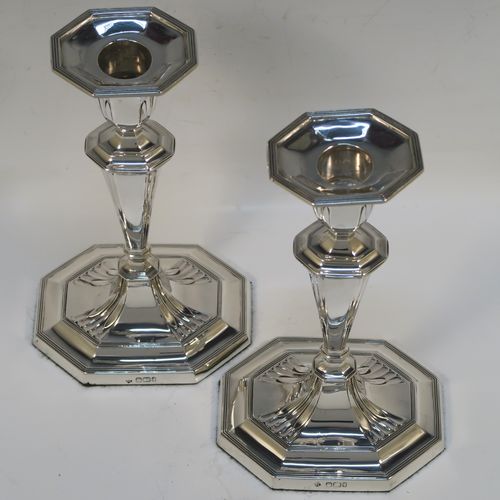 A very elegant Antique Victorian Sterling Silver pair of candlesticks, having octagonal bodies with hand-chased fluted decoration, reed-edged borders, and removable nozzles. These handsome antique silver candlesticks were made by Martin & Hall of Sheffield in 1901. The dimensions of these fine hand-made antique silver candlesticks are height 18.5 cms (7.25 inches), and the bases are 10 cms (4 inches) long, by 8 cms (3 inches) wide.
