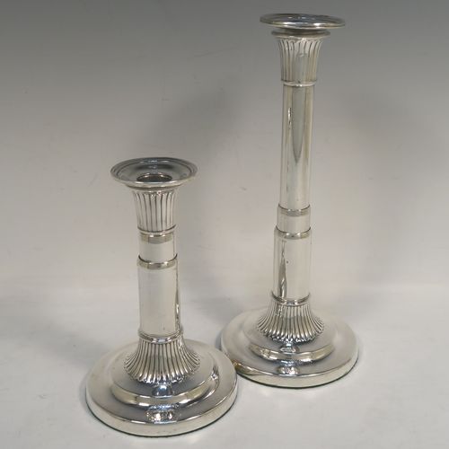A very handsome and rare pair of Antique Georgian Sterling Silver telescopic candlesticks, having round straight-sided columns, with fluted decoration round the tops and bases, and removable nozzles. These elegant antique silver telescopic candlesticks were made by George Ashfoed and Co., of Sheffield in 1800. The dimensions of these fine hand-made antique silver telescopic candlesticks are height collapsed 18 cms (5 inches), extended 27 cms (10.5 inches), and the diameter of the bases are 11.5 cms (4.5 inches). Please note that these items are part crested. 