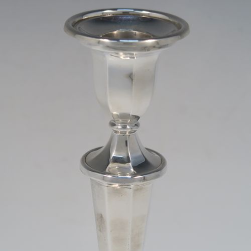 An elegant Sterling Silver pair of candlesticks, having plain octagonal bodies, sitting on round bases, and round removable nozzles. These handsome silver candlesticks were made by Roberts and Belk of Sheffield in 1972. The dimensions of these fine hand-made silver candlesticks are height 21 cms (8.25 inches), and the bases are 9.5 cms (3.75 inches) in diameter.