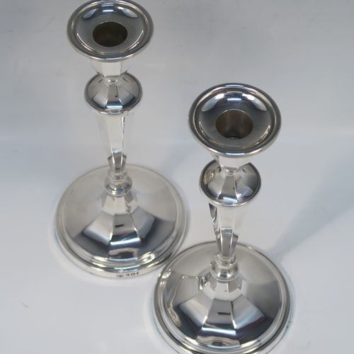 An elegant Sterling Silver pair of candlesticks, having plain octagonal bodies, sitting on round bases, and round removable nozzles. These handsome silver candlesticks were made by Roberts and Belk of Sheffield in 1972. The dimensions of these fine hand-made silver candlesticks are height 21 cms (8.25 inches), and the bases are 9.5 cms (3.75 inches) in diameter.