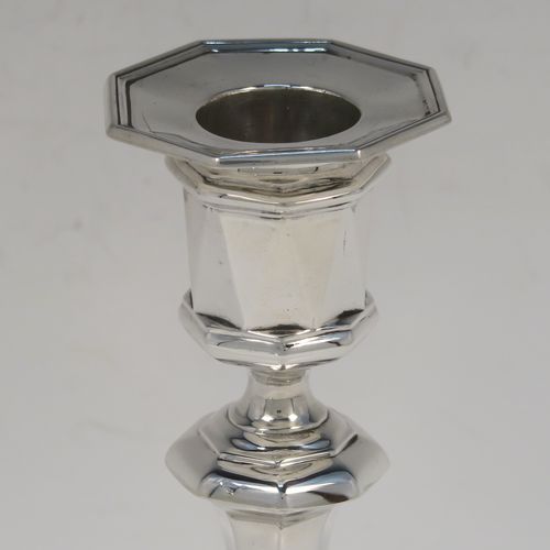 A very elegant Antique Sterling Silver pair of candlesticks, having octagonal panelled bodies, with reed-edged borders, and removable nozzles. These handsome antique silver candlesticks were made by Hawksworth and Eyers of Sheffield in 1920. The dimensions of these fine hand-made antique silver candlesticks are height 15 cms (6 inches), and the bases are 8.5 cms (3.3 inches) at their widest point.  