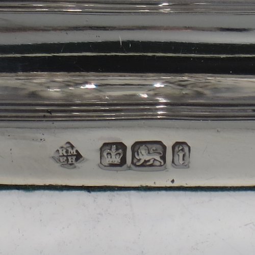 An Antique Victorian Sterling Silver pair of small candlesticks, having octagonal bases with hand-chased fluted decoration, reed-edged borders, and removable nozzles. Made by Martin & Hall of Sheffield in 1901. The dimensions of these fine hand-made antique silver candlesticks are height 10 cms (4 inches), and the bases are 11 cms (4.3 inches) long, by 8.5 cms (3.3 inches).