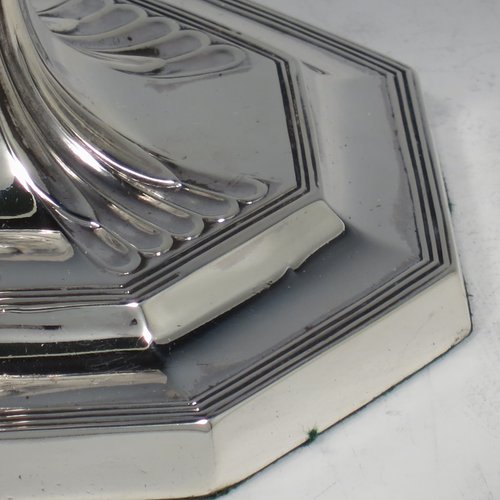 An Antique Victorian Sterling Silver pair of small candlesticks, having octagonal bases with hand-chased fluted decoration, reed-edged borders, and removable nozzles. Made by Martin & Hall of Sheffield in 1901. The dimensions of these fine hand-made antique silver candlesticks are height 10 cms (4 inches), and the bases are 11 cms (4.3 inches) long, by 8.5 cms (3.3 inches).