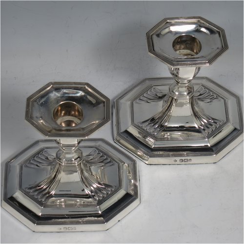 An Antique Victorian Sterling Silver pair of small candlesticks, having octagonal bases with hand-chased fluted decoration, reed-edged borders, and removable nozzles. Made by Martin & Hall of Sheffield in 1901. The dimensions of these fine hand-made antique silver candlesticks are height 10 cms (4 inches), and the bases are 11 cms (4.3 inches) long, by 8.5 cms (3.3 inches).