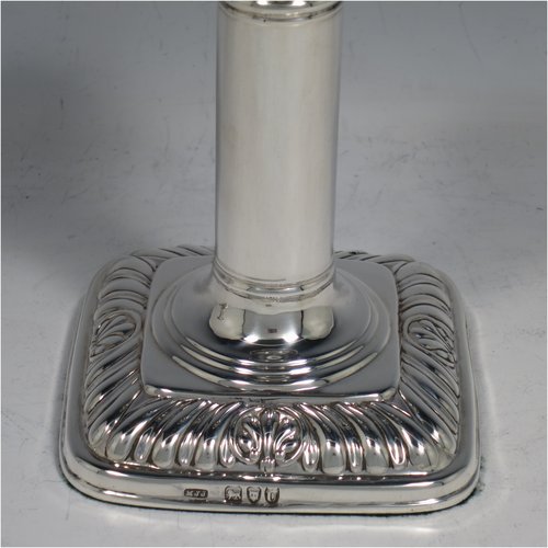 An Antique Victorian Sterling Silver pair of candlesticks, in a Georgian Regency style with plain round columns on square bases with rounded corners, gadroon edged borders, and removable nozzles. Made by Matthew John Jessop of London in 1895. The dimensions of this fine pair of hand-made silver candlesticks are height 14 cms (5.5 inches), and the bases are 9 cms (3.5 inches) square.