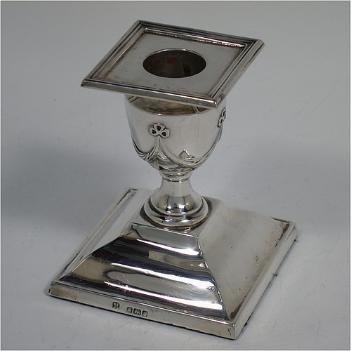 An Antique Victorian Sterling Silver very pretty pair of small candlesticks, having neoclassical style decoration with rectangular bases, with hand-chased bows and swags, and removable nozzles with applied reeded borders. Made by William Angus Fraser of Sheffield in 1894. The dimensions of these fine hand-made antique silver candlesticks are height 8 cms (3.25 inches), and the bases are 7 cms (2.75 inches) square.