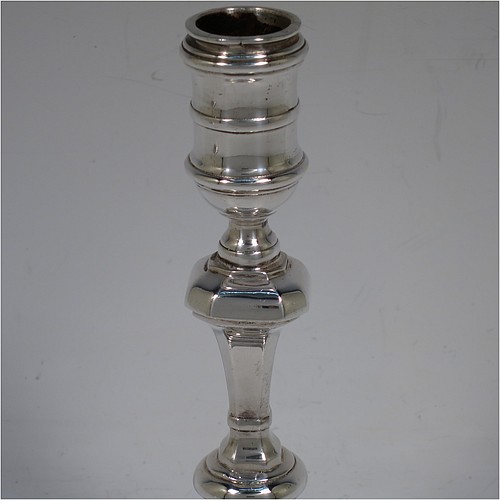 A very handsome Sterling Silver pair of cast candlesticks in a George I style, having octagonal baluster bodies, and sitting on hexagonal bases. Made in London in 1992. The dimensions of these fine hand-made cast silver table candlesticks are height 17 cms (6.75 inches), and the bases are 10 cms (4 inches) square.