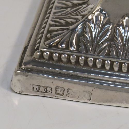 A very pretty Antique Edwardian Sterling Silver pair of candlesticks, in a Neoclassical style with hand-chased bows, swags, and acanthus leaves, with bead-edged borders, removable nozzles, and square bases. This beautiful pair of antique silver candlesticks were made by Thomas Scot of Sheffield in 1908. The dimensions of this fine pair of hand-made antique silver candlesticks are height 16 cms (6.3 inches), and the bases are 8 cms (3.25 inches) square.