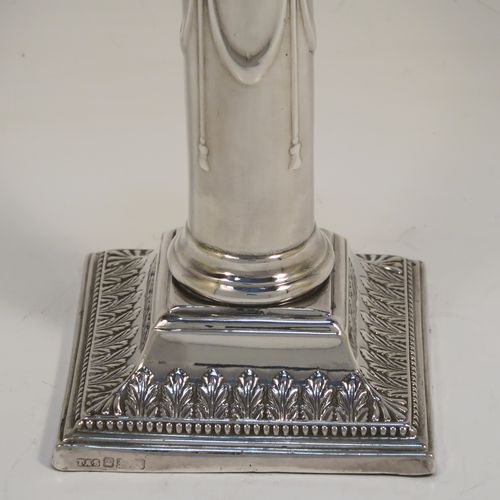 A very pretty Antique Edwardian Sterling Silver pair of candlesticks, in a Neoclassical style with hand-chased bows, swags, and acanthus leaves, with bead-edged borders, removable nozzles, and square bases. This beautiful pair of antique silver candlesticks were made by Thomas Scot of Sheffield in 1908. The dimensions of this fine pair of hand-made antique silver candlesticks are height 16 cms (6.3 inches), and the bases are 8 cms (3.25 inches) square.