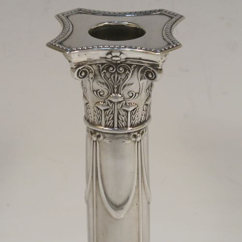 A very pretty Antique Edwardian Sterling Silver pair of candlesticks, in a Neoclassical style with hand-chased bows, swags, and acanthus leaves, with bead-edged borders, removable nozzles, and square bases. This beautiful pair of antique silver candlesticks were made by Thomas Scot of Sheffield in 1908. The dimensions of this fine pair of hand-made antique silver candlesticks are height 16 cms (6.3 inches), and the bases are 8 cms (3.25 inches) square.
