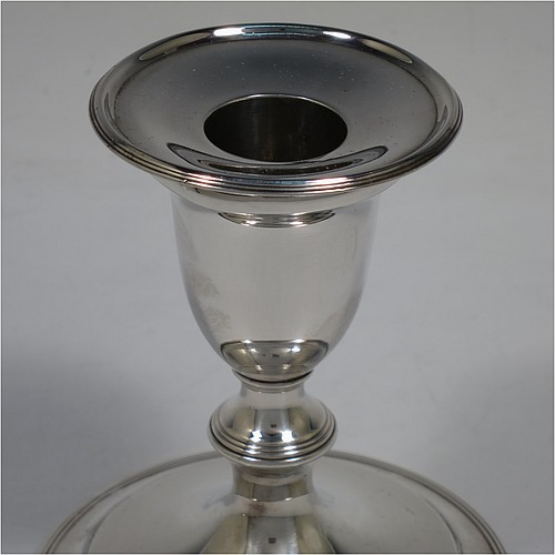 A very handsome pair of Antique Georgian Sterling Silver candlesticks, in a very plain round style, having baluster bodies with hand-chased reeded borders and original removable nozzles. Made by Nathaniel Smith and Co., of Sheffield in 1804. The dimensions of these fine hand-made antique silver candlesticks are height 11.5 cms (4.5 inches), and the bases are 10 cms (4 inches) in diameter.    