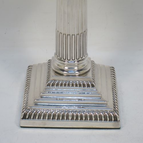 A very pretty pair of Antique Victorian Sterling Silver of Corinthian style candlesticks, having traditional gadroon borders, acanthus-leaf capitals, fluted columns, removable nozzles, and square stepped bases. Made by William Hutton of London in 1901. The dimensions of this fine hand-made pair of antique silver candlesticks are height 16 cms (6.25 inches), and the bases are 8.5 cms (3.3 inches) square.