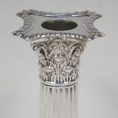 A very pretty pair of Antique Victorian Sterling Silver of Corinthian style candlesticks, having traditional gadroon borders, acanthus-leaf capitals, fluted columns, removable nozzles, and square stepped bases. Made by William Hutton of London in 1901. The dimensions of this fine hand-made pair of antique silver candlesticks are height 16 cms (6.25 inches), and the bases are 8.5 cms (3.3 inches) square.