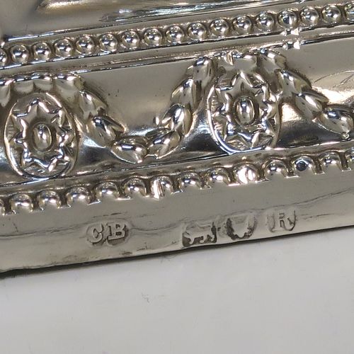 A very pretty pair of Antique Victorian Sterling Silver candlesticks, having urn-shaped bodies sitting on square pedestal bases, with hand-chased neoclassical style decoration, bead-edged borders, and removable nozzles. These beautiful antique silver candlesticks were made by Charles Boyton of London in 1892. The dimensions of these fine hand-made silver candlesticks are height 11 cms (4.3 inches), and the bases are 8.5 cms (3.3 inches) square.

  