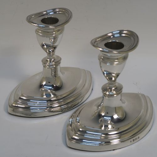 A very handsome pair of Antique Sterling Silver candlesticks, having plain oval boat-shaped bodies with reeded borders, and original removable nozzles. These elegant antique silver candlesticks were made by Williams Ltd., of Birmingham in 1911. The dimensions of these fine hand-made antique silver candlesticks are height 11.5 cms (4.5 inches), and the bases are 14 cms (5.5 inches) long.   