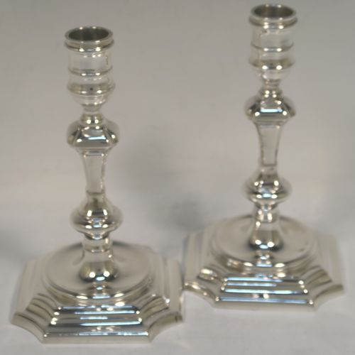 A very handsome pair of cast Sterling Silver candlesticks in a George I style, having plain cut-cornered and panelled baluster bodies. These elegant cast silver candlesticks were made by J. B. Chatterley and Sons Ltd., of Birmingham in 1974. The dimensions of this fine pair of hand-made cast sterling silver table candlesticks are height 15 cms (6 inches), the bases are 9 cms (3.5 inches) square, and the total weight is 618g (20 troy ounces).   
