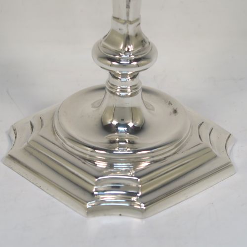 A very handsome pair of cast Sterling Silver candlesticks in a George I style, having plain cut-cornered and panelled baluster bodies. These elegant cast silver candlesticks were made by J. B. Chatterley and Sons Ltd., of Birmingham in 1974. The dimensions of this fine pair of hand-made cast sterling silver table candlesticks are height 15 cms (6 inches), the bases are 9 cms (3.5 inches) square, and the total weight is 618g (20 troy ounces).
