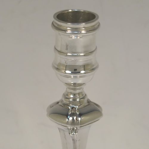 A very handsome pair of cast Sterling Silver candlesticks in a George I style, having plain cut-cornered and panelled baluster bodies. These elegant cast silver candlesticks were made by J. B. Chatterley and Sons Ltd., of Birmingham in 1974. The dimensions of this fine pair of hand-made cast sterling silver table candlesticks are height 15 cms (6 inches), the bases are 9 cms (3.5 inches) square, and the total weight is 618g (20 troy ounces).
