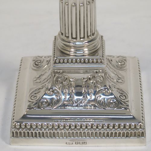 A very pretty pair of Antique Edwardian Sterling Silver of Corinthian style candlesticks, having bead-edged borders, acanthus-leaf capitals, fluted columns, removable nozzles, and square stepped bases. These beautiful antique silver candlesticks were made by James Dixon and Sons of Sheffield in 1907. The dimensions of this fine hand-made pair of antique silver candlesticks are height 17 cms (6.75 inches), and the bases are 9 cms (3.5 inches) square.
