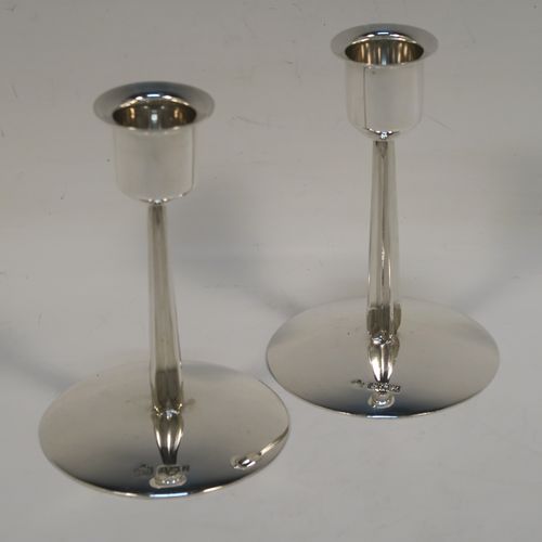 A very unusual Sterling Silver pair of modernistic style candlesticks, having plain round nozzles, plain cross-section style columns, and sitting on plain round bases. These very individual silver candlestick holders were made by Elkington and Co., of Birmingham in 1961. The dimensions of these fine hand-made silver candlesticks are height 11 cms (4.3 inches), diameter at base 7.5 cms (3 inches), and with a total weight of approx. 163g (5.3 troy ounces). Please note that these candlesticks are not loaded.   