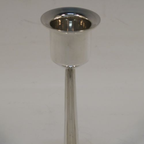 A very unusual Sterling Silver pair of modernistic style candlesticks, having plain round nozzles, plain cross-section style columns, and sitting on plain round bases. These very individual silver candlestick holders were made by Elkington and Co., of Birmingham in 1961. The dimensions of these fine hand-made silver candlesticks are height 11 cms (4.3 inches), diameter at base 7.5 cms (3 inches), and with a total weight of approx. 163g (5.3 troy ounces). Please note that these candlesticks are not loaded.   