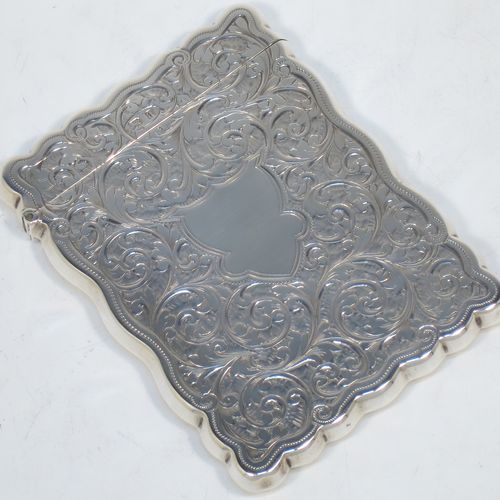 A very elegant Antique Victorian Sterling Silver calling card case, having a shaped rectangular body with hand-engraved floral and scroll decoration, a gold-gilt interior, a vacant central cartouche on one side, and a side-hinged lid. Made by Walker and Hall of Birmingham in 1900. The dimensions of this fine hand-made antique silver card case are length 9.5 cms (3.75 inches), width 7 cms (2.75 inches), and it weighs approx. 74g (2.4 troy ounces).   