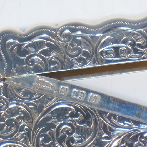 A very elegant Antique Victorian Sterling Silver calling card case, having a shaped rectangular body with hand-engraved floral and scroll decoration, a gold-gilt interior, a vacant central cartouche on one side, and a side-hinged lid. Made by Walker and Hall of Birmingham in 1900. The dimensions of this fine hand-made antique silver card case are length 9.5 cms (3.75 inches), width 7 cms (2.75 inches), and it weighs approx. 74g (2.4 troy ounces).