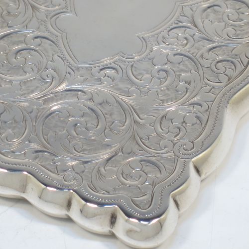 A very elegant Antique Victorian Sterling Silver calling card case, having a shaped rectangular body with hand-engraved floral and scroll decoration, a gold-gilt interior, a vacant central cartouche on one side, and a side-hinged lid. Made by Walker and Hall of Birmingham in 1900. The dimensions of this fine hand-made antique silver card case are length 9.5 cms (3.75 inches), width 7 cms (2.75 inches), and it weighs approx. 74g (2.4 troy ounces).