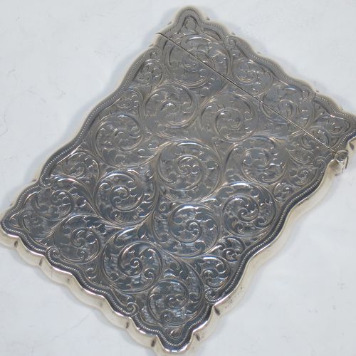 A very elegant Antique Victorian Sterling Silver calling card case, having a shaped rectangular body with hand-engraved floral and scroll decoration, a gold-gilt interior, a vacant central cartouche on one side, and a side-hinged lid. Made by Walker and Hall of Birmingham in 1900. The dimensions of this fine hand-made antique silver card case are length 9.5 cms (3.75 inches), width 7 cms (2.75 inches), and it weighs approx. 74g (2.4 troy ounces).