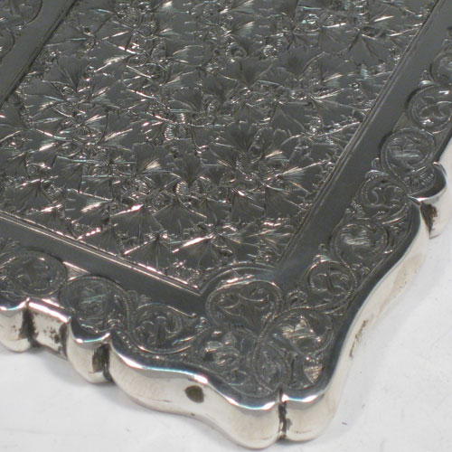 Antique Victorian sterling silver calling card case, having a shaped rectangular body with hand-engraved floral decoration (gingko leaves), and a side-hinged lid. Made in Birmingham in 1879. The dimensions of this fine hand-made silver card case are length 10 cms (4 inches), width 7 cms (2.75 inches), and it weighs approx. 60g (2 troy ounces).