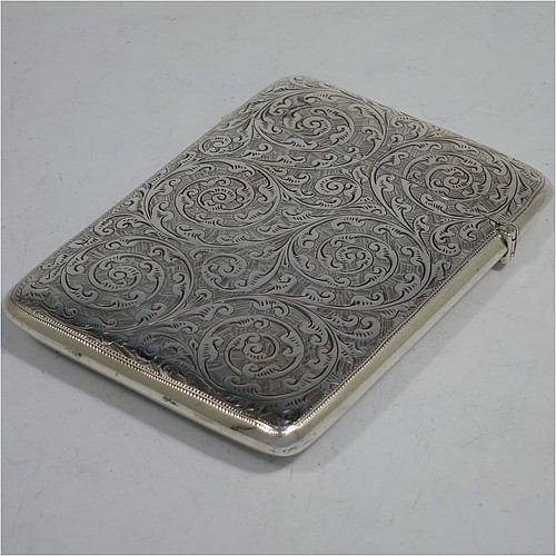 A very pretty Antique Victorian Sterling Silver calling card case, having a rectangular body with rounded shoulders, hand-engraved floral decoration, a vacant central cartouche on one side, and a side-hinged lid. Made by George Loveridge of Birmingham in 1898. The dimensions of this fine hand-made antique silver card case are length 10 cms (4 inches), width 7.5 cms (3 inches), and it weighs approx. 88g (2.8 troy ounces).