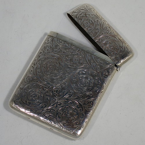 A very pretty Antique Victorian Sterling Silver calling card case, having a rectangular body with rounded shoulders, hand-engraved floral decoration, a vacant central cartouche on one side, and a side-hinged lid. Made by George Loveridge of Birmingham in 1898. The dimensions of this fine hand-made antique silver card case are length 10 cms (4 inches), width 7.5 cms (3 inches), and it weighs approx. 88g (2.8 troy ounces).