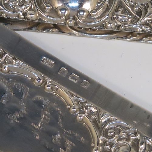 A very pretty Antique Edwardian Sterling Silver Castle-Top card case, having a hand-chased rectangular body with floral and scroll decoration, together with a scene of Royal Windsor Castle on one side, a hanged lid, and a vacant cartouches on the other side. This beautiful antique silver card case was made by Crisford and Norris of Birmingham in 1906. The dimensions of this fine hand-made antique silver card case are length 10 cms (4 inches), width 7 cms (2.75 inches), and it weighs approx. 58g (1.9 troy ounces).