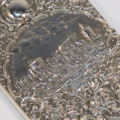 A very pretty Antique Edwardian Sterling Silver Castle-Top card case, having a hand-chased rectangular body with floral and scroll decoration, together with a scene of Royal Windsor Castle on one side, a hanged lid, and a vacant cartouches on the other side. This beautiful antique silver card case was made by Crisford and Norris of Birmingham in 1906. The dimensions of this fine hand-made antique silver card case are length 10 cms (4 inches), width 7 cms (2.75 inches), and it weighs approx. 58g (1.9 troy ounces).