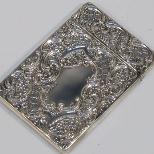 A very pretty Antique Edwardian Sterling Silver Castle-Top card case, having a hand-chased rectangular body with floral and scroll decoration, together with a scene of Royal Windsor Castle on one side, a hanged lid, and a vacant cartouches on the other side. This beautiful antique silver card case was made by Crisford and Norris of Birmingham in 1906. The dimensions of this fine hand-made antique silver card case are length 10 cms (4 inches), width 7 cms (2.75 inches), and it weighs approx. 58g (1.9 troy ounces).