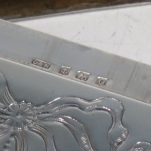 A very pretty Antique Sterling Silver calling card case, having a rectangular body with rounded shoulders, hand-engraved neoclassical style floral decoration on the front with a plain undecorated rear side, and a side-hinged lid. Made by Crisford and Norris Ltd., of Birmingham in 1913. The dimensions of this fine hand-made antique silver card case are length 10 cms (4 inches), width 7 cms (2.75 inches), and it weighs approx. 67g (2.2 troy ounces).
